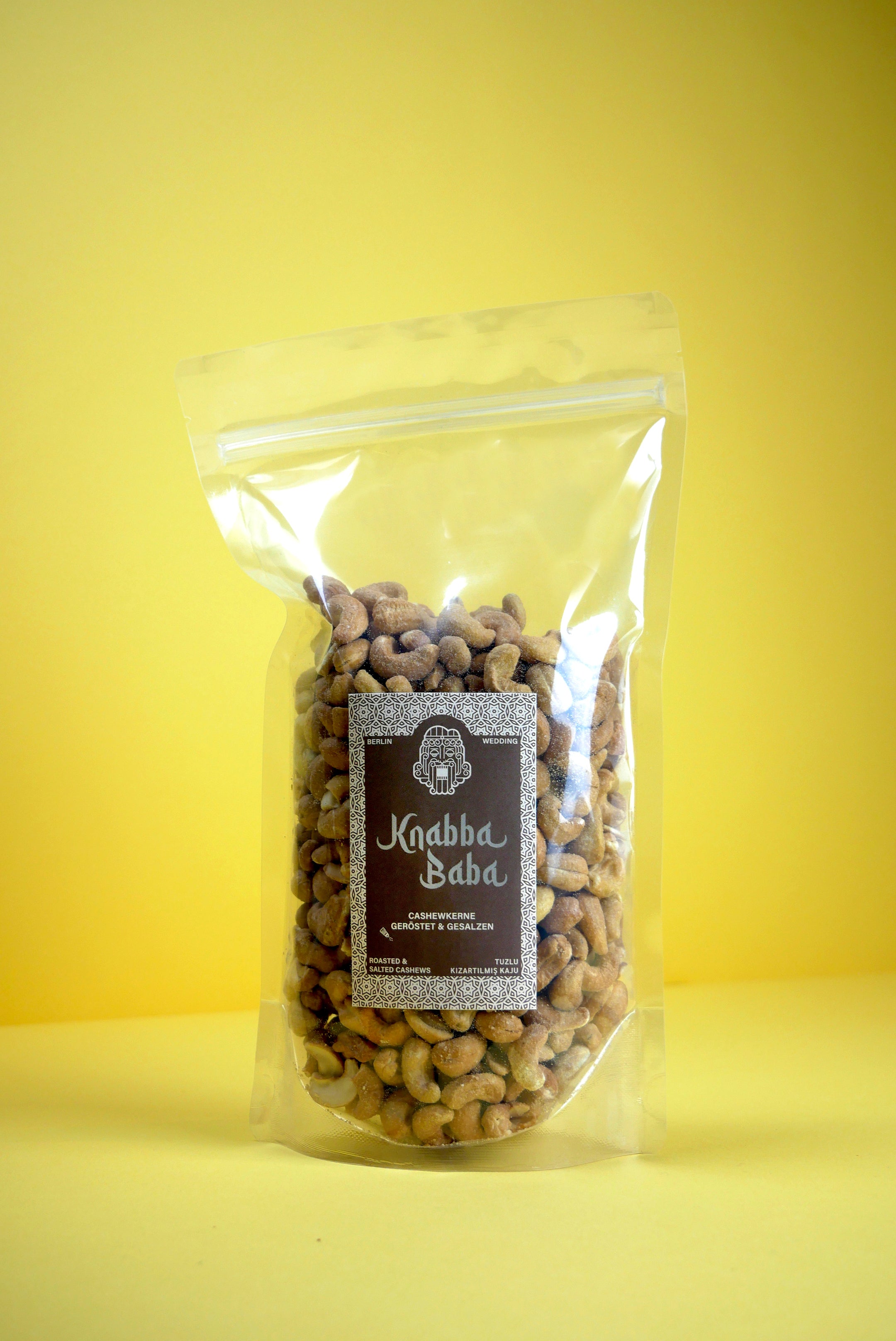 Knabba Baba geröstete Cashewnüsse im wiederverschließbaren 500 g Beutel vor gelbem Hintergrund